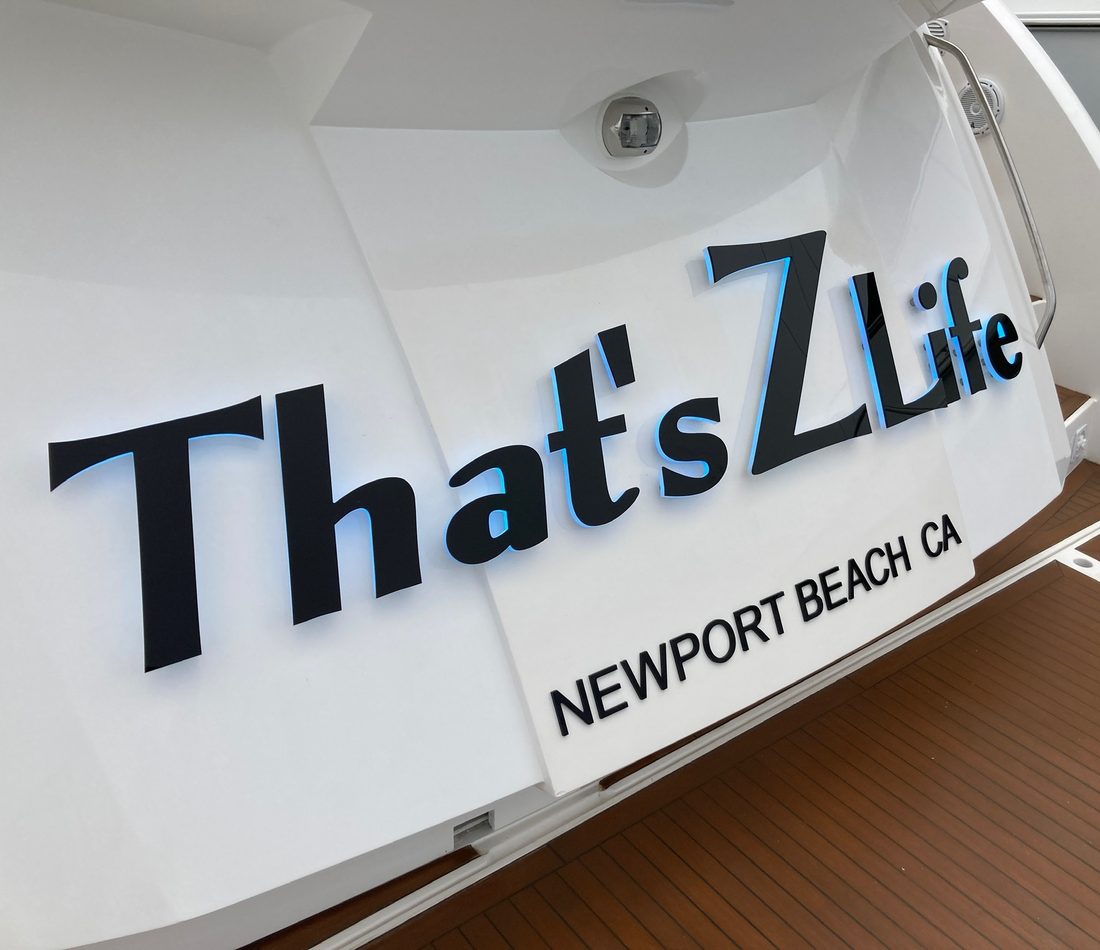 Backlit custom yacht name lettering reading That's Z Life on a transom in Newport Beach, CA